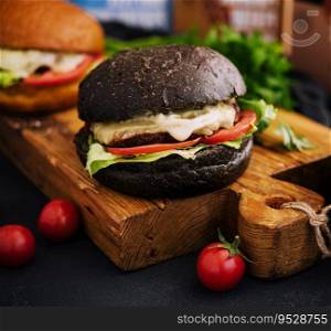 Modern black burger on wooden board