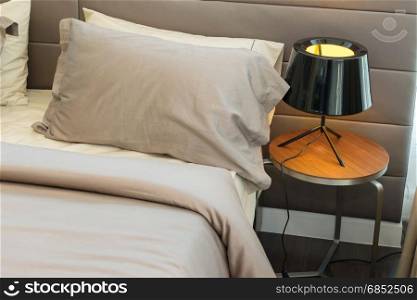 modern black lamp and brown pillow on bed