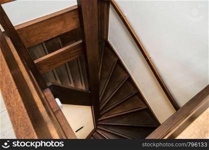 Modern brown oak wooden stairs in new renovated house interior, modern dark brown design. Modern brown oak wooden stairs in new renovated house interior