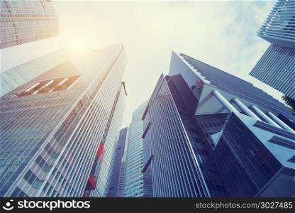 Modern building at business center city. Look up view with sunli. Modern building at business center city. Look up view with sunlight. Architecture, construction, investment, finance. Abstract background.