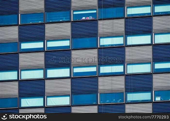 Modern building blue and white facade with widnows close up. Modern building facade with widnows close up