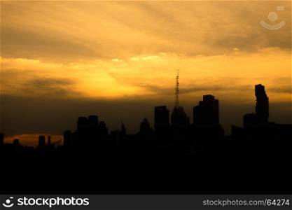 modern building business in city silhouette black shadow and big cloudy sky at sunset background