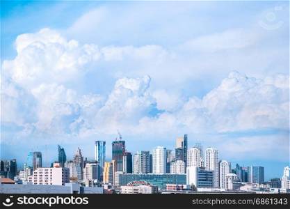 modern building in city and big blue cloudy sky background
