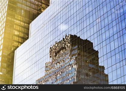 modern building reflected on a glass wall windows