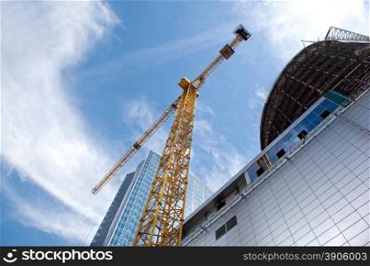 Modern building under construction against blue sky