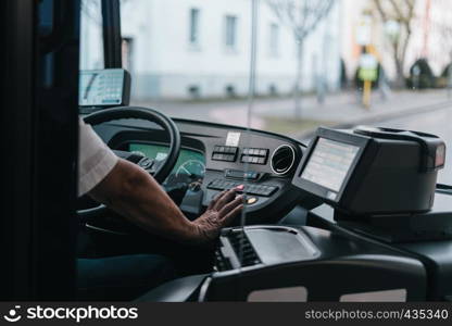 Modern bus interior with drivers hand