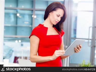 Modern business woman in the office with tablet. Modern successful business woman