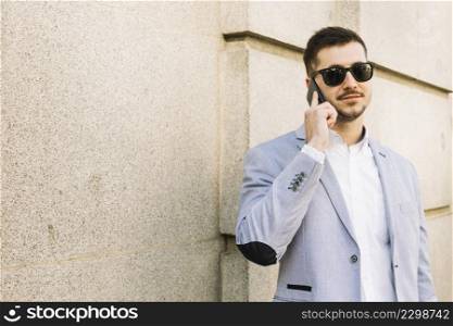 modern businessman making phone call outdoors