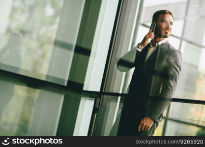 Modern businessman talking over the phone in the office