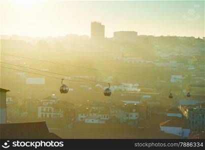 Modern cable cars in Porto at sunset. Gaia city on the background. Portugal