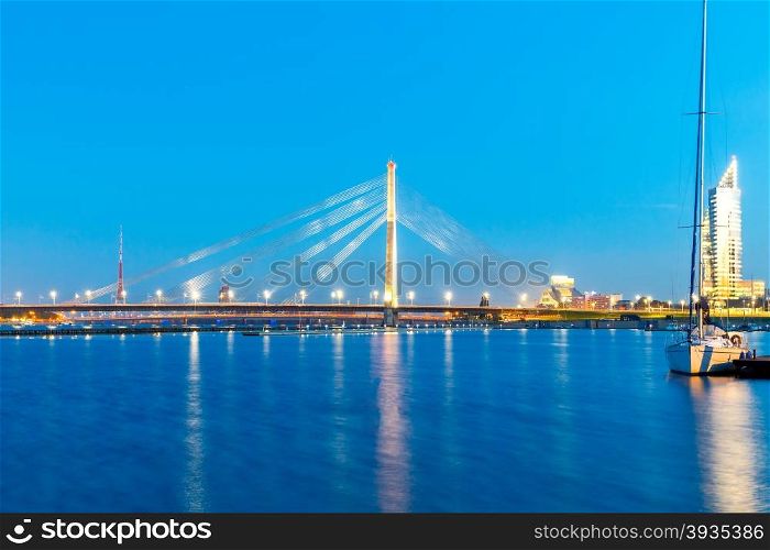 Modern cable-stayed bridge across the Daugava River in Riga night.. Riga. Cable-stayed bridge.