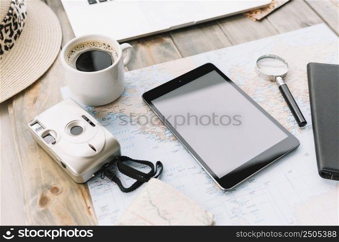 modern camera coffee cup digital tablet magnifying glass map