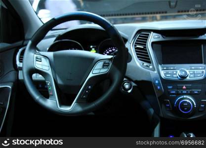 Modern car interior, luxurious materials in different shades of grey. Modern car interior