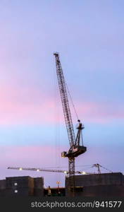 Modern carne on the construction building in twilight time.