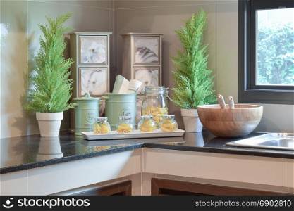 modern ceramic kitchenware and utensils on the black granite counter top
