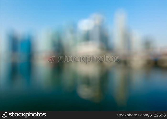Modern city defocused blurred background - Singapore business district skyscrapers and Marina Bay in day. Modern city defocused blurred background