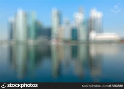 Modern city defocused blurred background - Singapore business district skyscrapers and Marina Bay in day