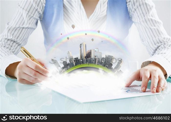 Modern city development design. Close view of businesswoman writing with pen and urban landscape on papers