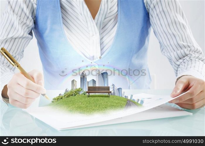 Modern city development design. Close view of businesswoman writing with pen and urban landscape on papers