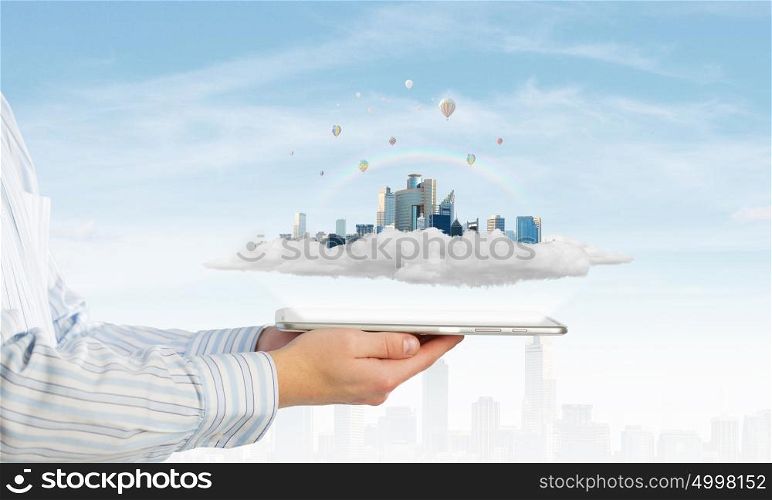 Modern city model. Hand holding tablet computer with cityscape on screen