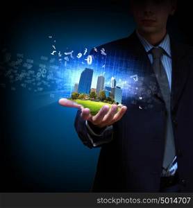 Modern cityscape. Image of a modern cityscape in the hand of a businessman