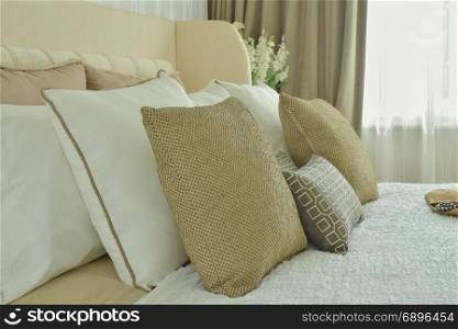 Modern classic style bedding with brown, beige and light brown pillows