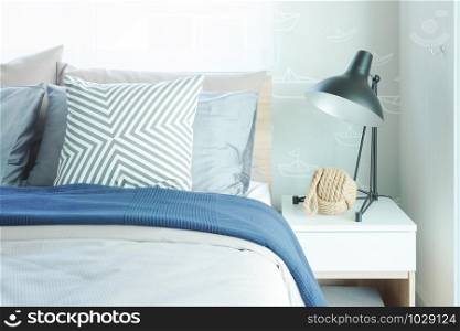 Modern classic style interior bedroom with pillows and black reading lamp on bedside table