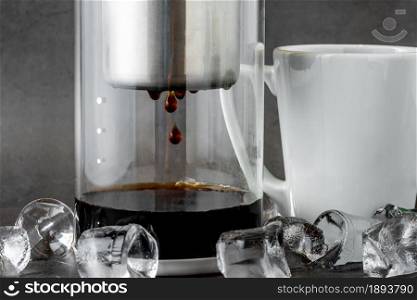 Modern Cold brew drip tower coffee maker on dark stone background