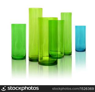 Modern colored glass vases row on white reflective background. Modern glass vases