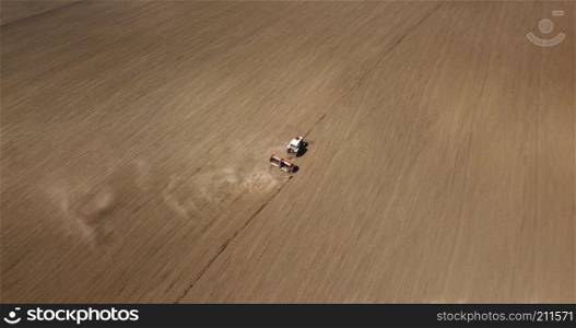 modern combine harvester works in the field. Sowing and harvesting. The concept of agronomy. Photo by drone. aerial view of harvest field with agricultural machinery carrying out work in the field