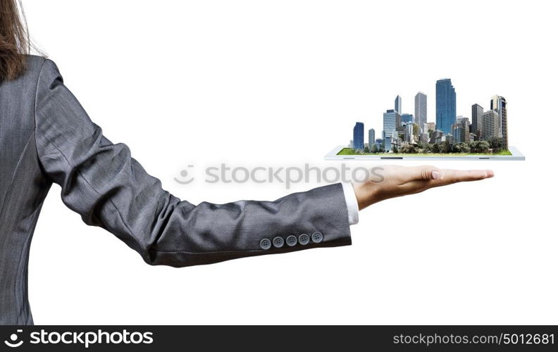 Modern construction. Back view of businesswoman holding in palm tablet pc with city image