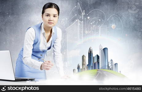 Modern construction development design. Young smiling businesswoman working with modern real estate concept