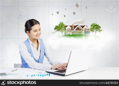 Modern construction development design. Young smiling businesswoman working with modern real estate concept