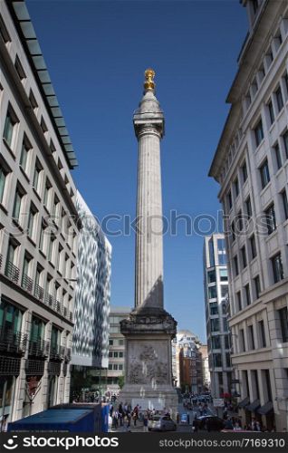 Modern-day View of the Monument to the Great Fire of London fluted Doric column built of Portland stone topped with a gilded urn of fire.. Modern-day View of the Monument to the Great Fire of London fluted Doric column built of Portland stone topped with a gilded urn of fire