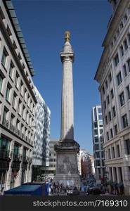 Modern-day View of the Monument to the Great Fire of London fluted Doric column built of Portland stone topped with a gilded urn of fire.. Modern-day View of the Monument to the Great Fire of London fluted Doric column built of Portland stone topped with a gilded urn of fire