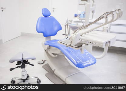 Modern dental practice. Dental chair and other accessories used by dentists.. Modern dental practice.