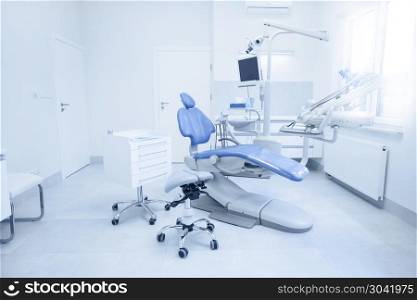 Modern dental practice. Dental chair and other accessories used by dentists.. Modern dental practice.
