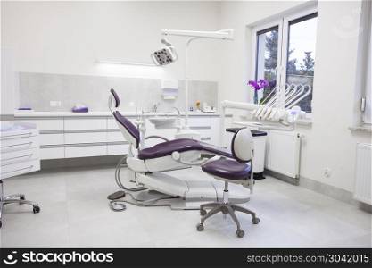 Modern dental practice. Dental chair and other accessories used by dentists.. Modern dental practice.