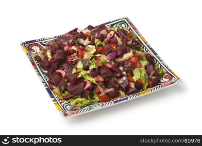 Modern designed dish with Moroccan beet salad on white background