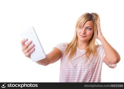 Modern devices, social media, photography concept. Blonde woman taking self picture, selfie, with tablet. Studio shot isolated. Woman taking self picture with tablet