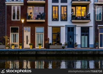 Modern dutch houses at the canal, city architecture by night, Alphen aan den Rijn, The Netherlands