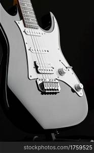Modern electric guitar, black background, nobody. String musical instrument, electro sound, electronic music, equipment for stage concert. Modern electric guitar, black background, nobody