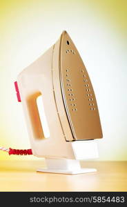 Modern electric iron against the colorful background