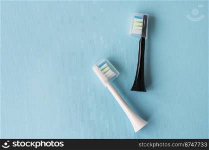Modern electric toothbrush on a blue background. Hygiene concept for daily oral care. Modern electric toothbrush on a blue background. Hygiene concept for daily oral care.