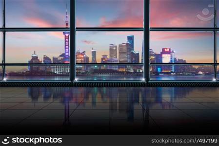 Modern empty and clean office interior with glass windows , shanghai pudong city skyline background , sunset scene .