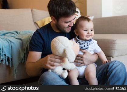 Modern father playing with little baby boy