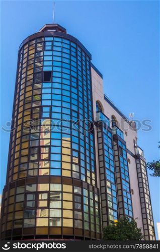 modern glass building with reflections and blue sky