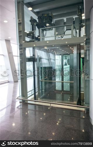 Modern glass elevator for disabled people at international airport