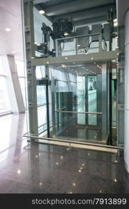 Modern glass elevator for disabled people at international airport