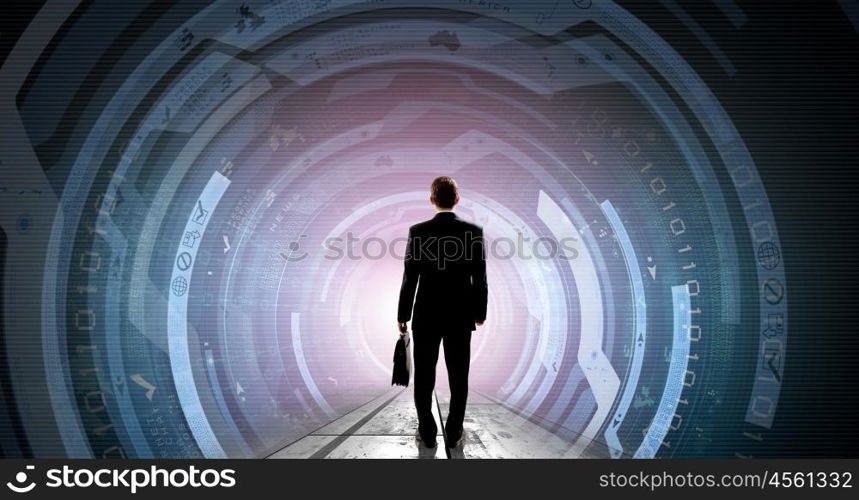 Modern global technologies. Back view of businessman with suitcase in hands looking at virtual panel